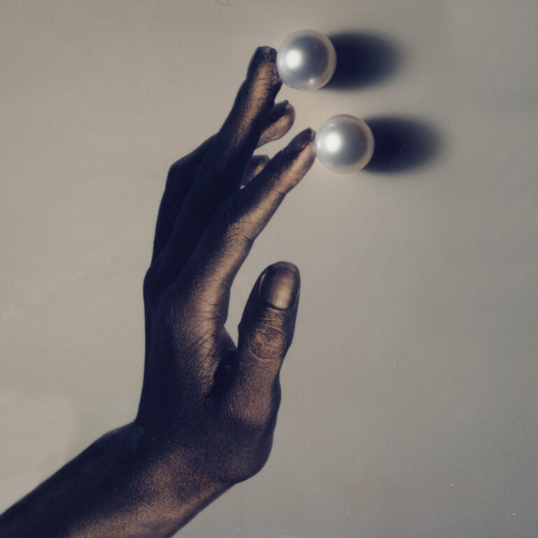 Hand touching pearls picture by Giovanni Gastel