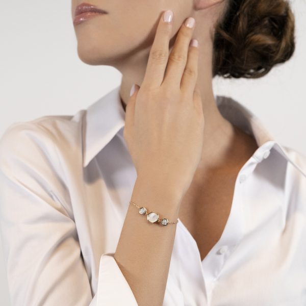 The model wears Venus collection bracelet with freshwater pearls mother of pearl and diamonds