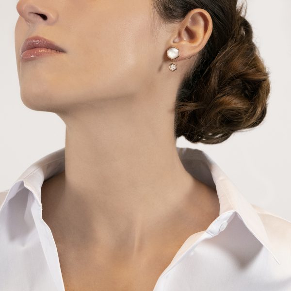 The model wears the Venus earrings with mother of pearl and diamonds