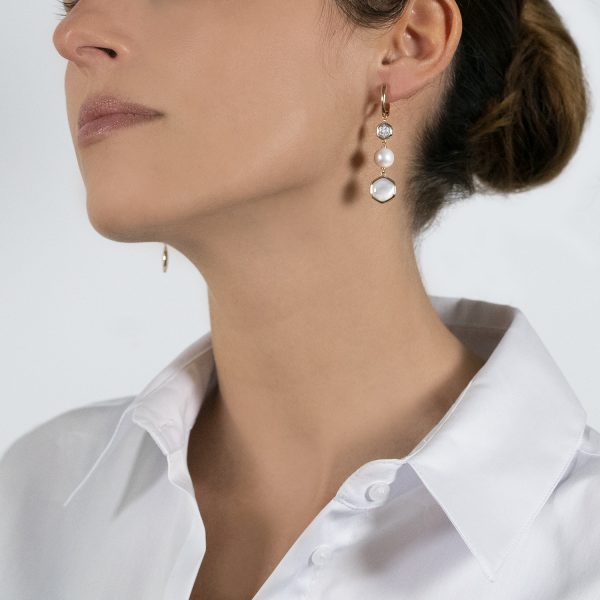 The model wears Venus collection earrings with freshwater pearls mother of pearl and diamonds