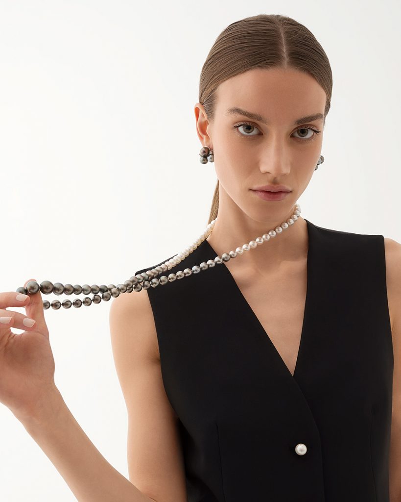 The model wears a long strand with South Sea and Tahiti pearls