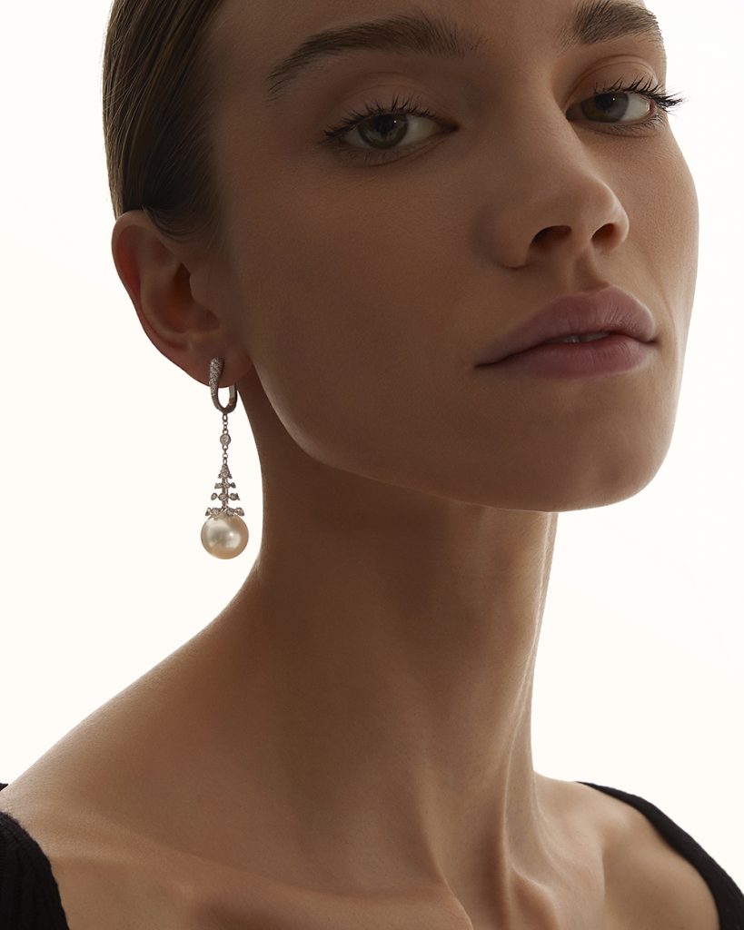 The model wears Notturno long earrings with South Sea pearls and diamonds